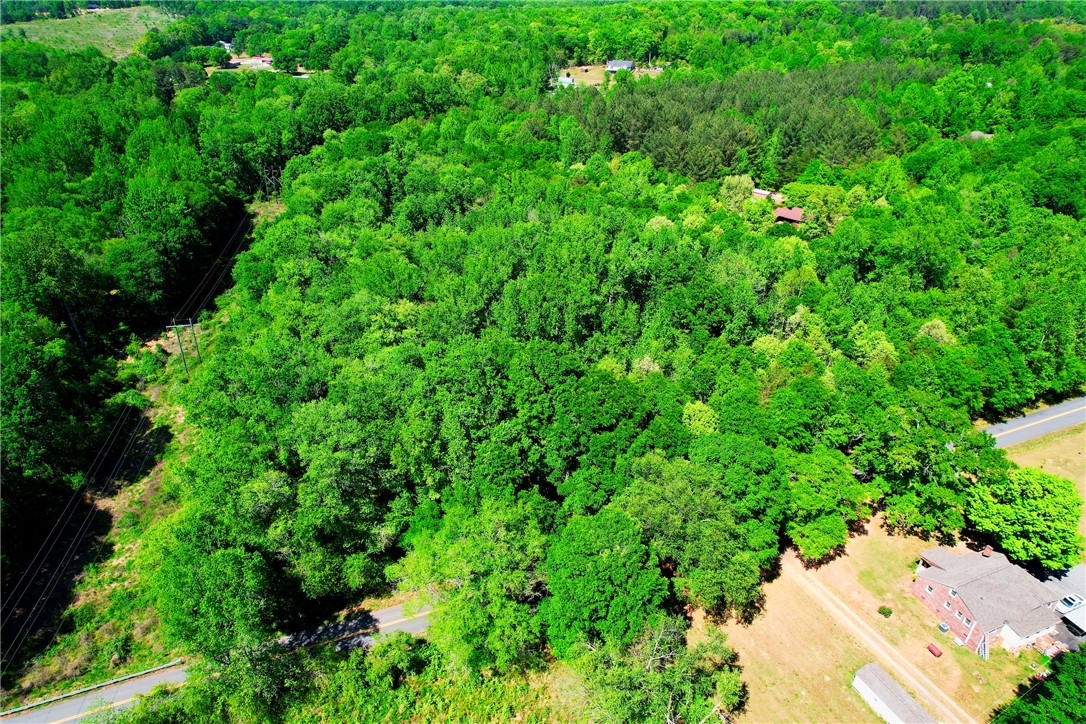 903 Cedar Rock Church Road Easley, SC 29640 - Photo 6 of 8 Expansive green landscape with clearings and access roads for your dream property.