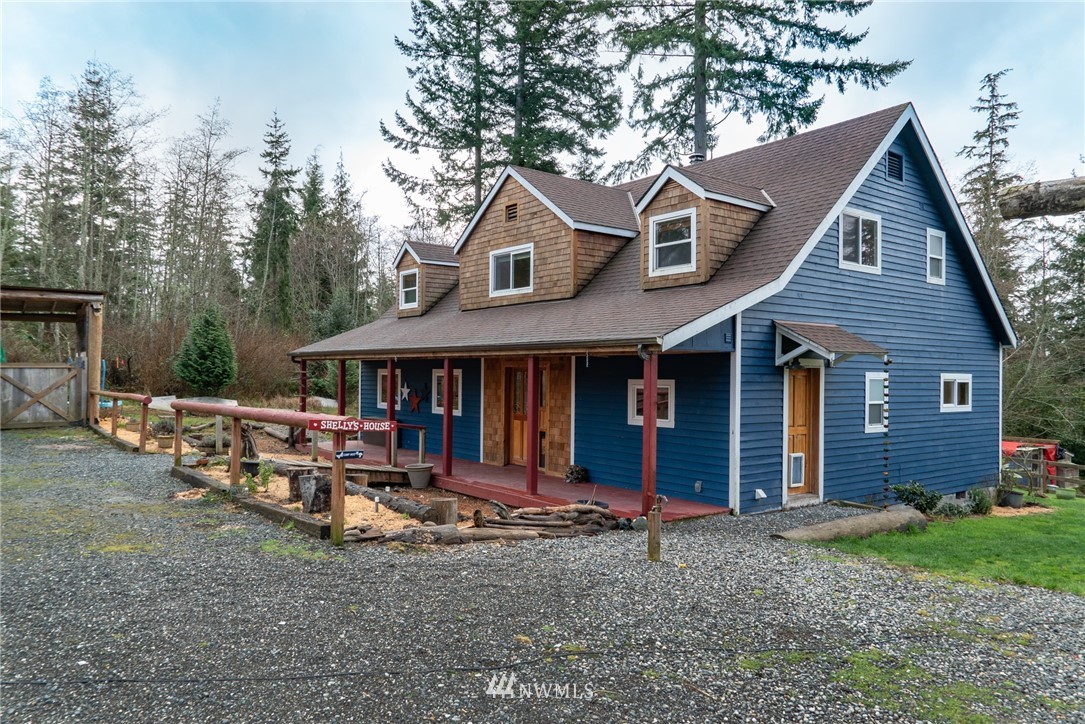 3399 East Harbor Road Langley, WA 98260 - Photo 1 of 36 a view of a house with a yard and lawn chairs