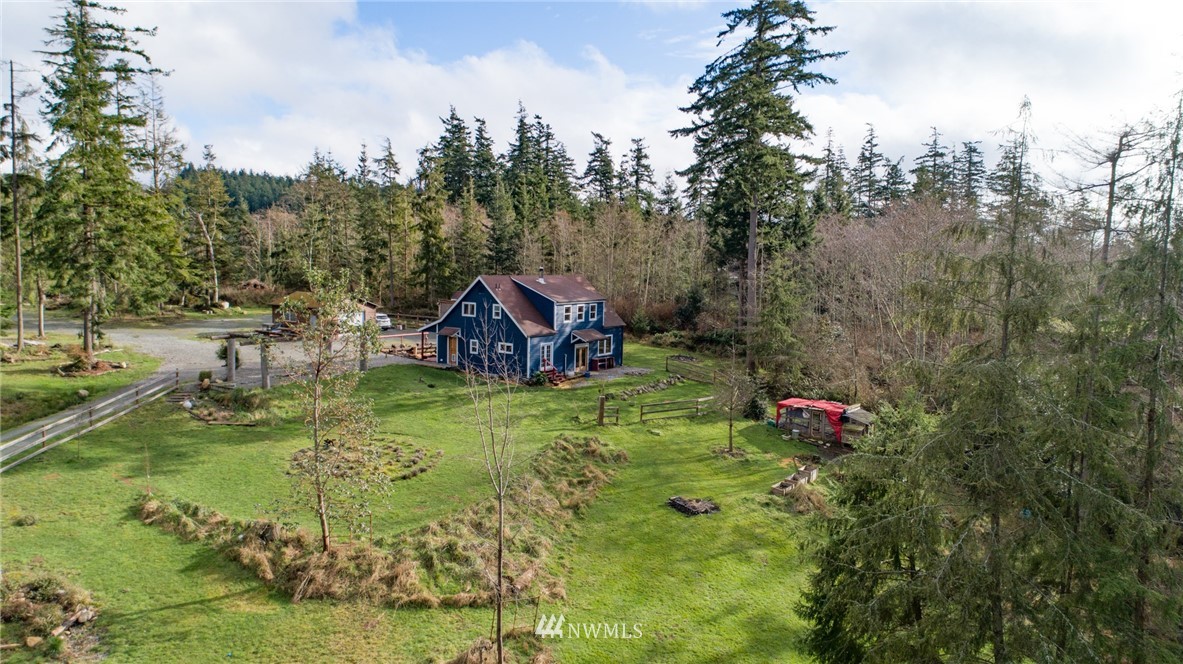 3399 East Harbor Road Langley, WA 98260 - Photo 2 of 36 a backyard of a house with a yard and trampoline