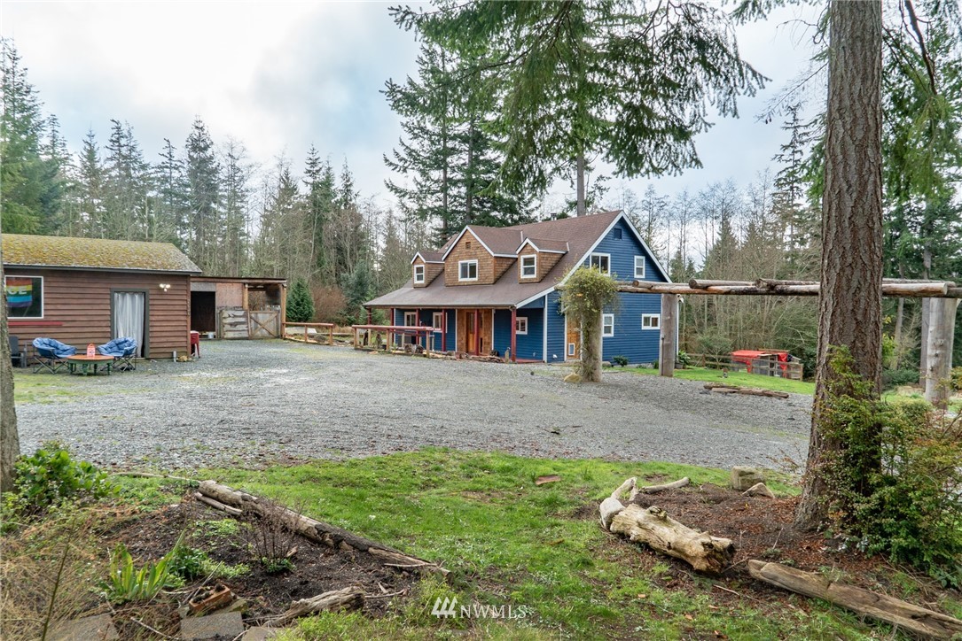 3399 East Harbor Road Langley, WA 98260 - Photo 12 of 36 a front view of a house with a yard and garage