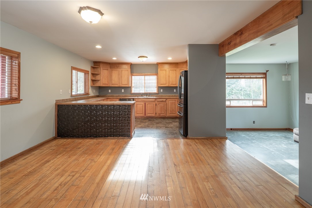 3399 East Harbor Road Langley, WA 98260 - Photo 18 of 36 a view of kitchen with wooden floor electronic appliances and window