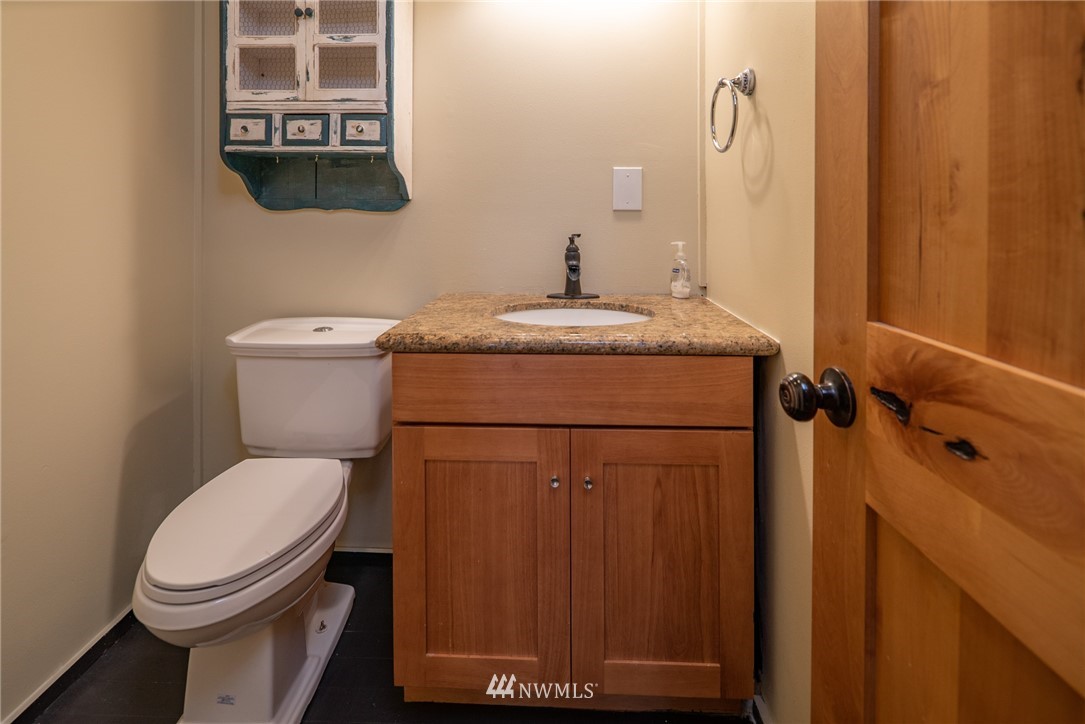 3399 East Harbor Road Langley, WA 98260 - Photo 25 of 36 a bathroom with a toilet and a mirror