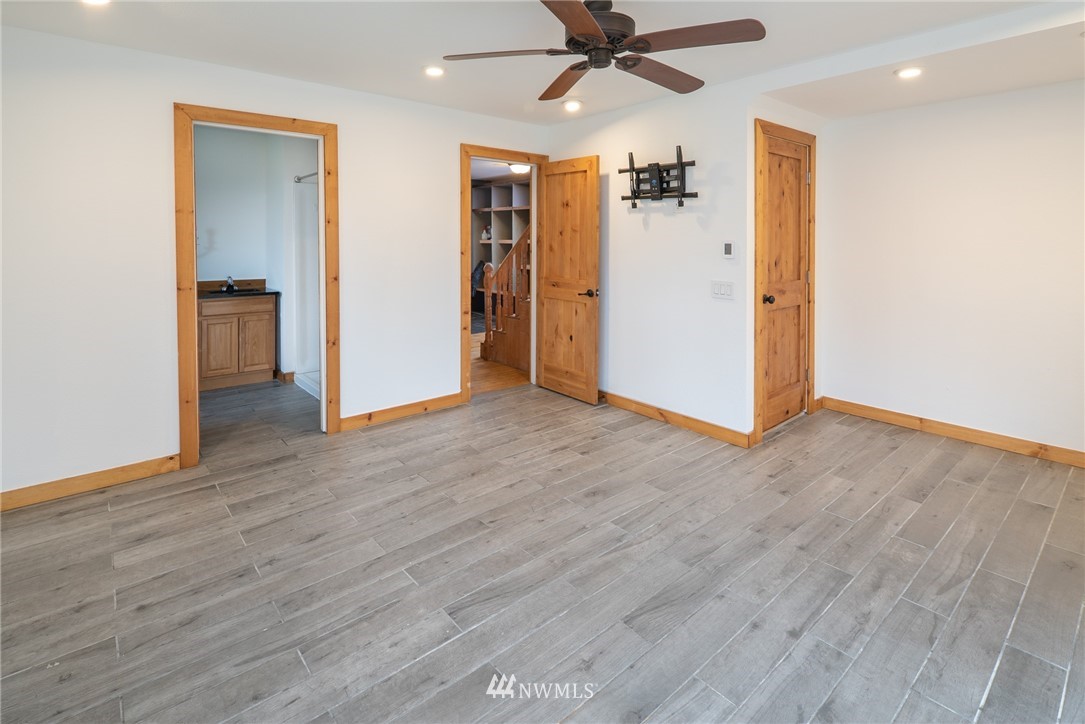 3399 East Harbor Road Langley, WA 98260 - Photo 29 of 36 a view of a livingroom with a ceiling fan hardwood floor and a ceiling fan
