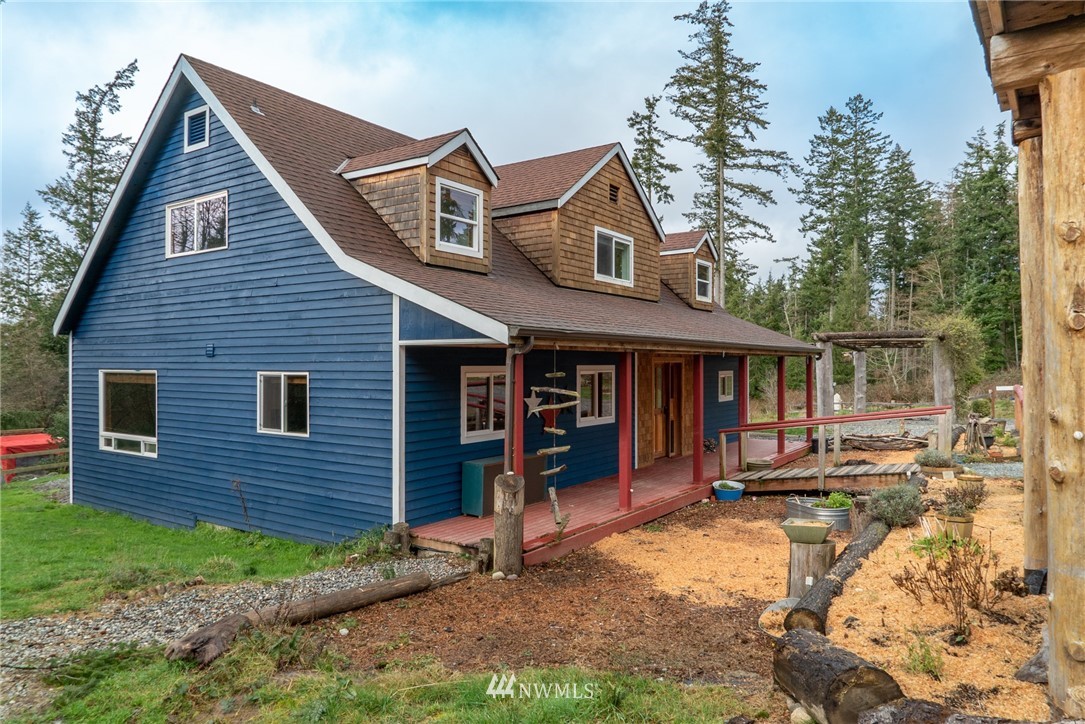 3399 East Harbor Road Langley, WA 98260 - Photo 7 of 36 a front view of a house with a yard and outdoor seating