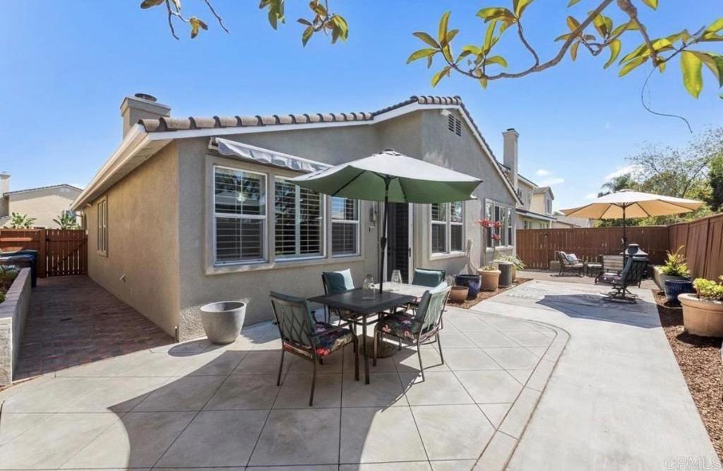 1113 Teal Way Oceanside, CA 92057 - Photo 2 of 3 a view of a patio with a table and chairs under an umbrella