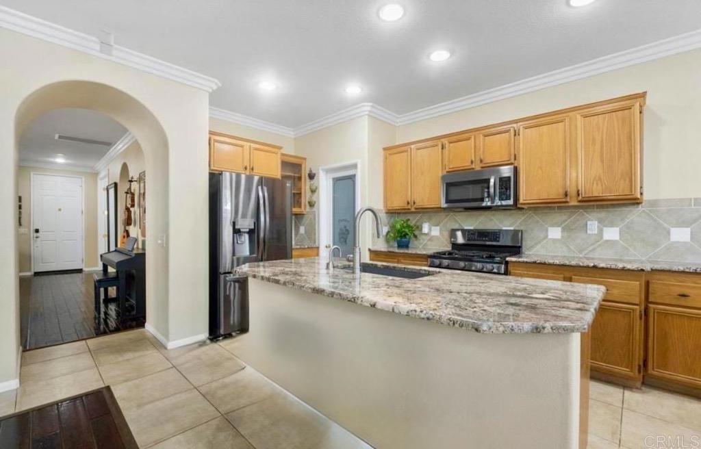 1113 Teal Way Oceanside, CA 92057 - Photo 3 of 3 a kitchen with stainless steel appliances granite countertop a refrigerator a stove top oven a sink and dishwasher