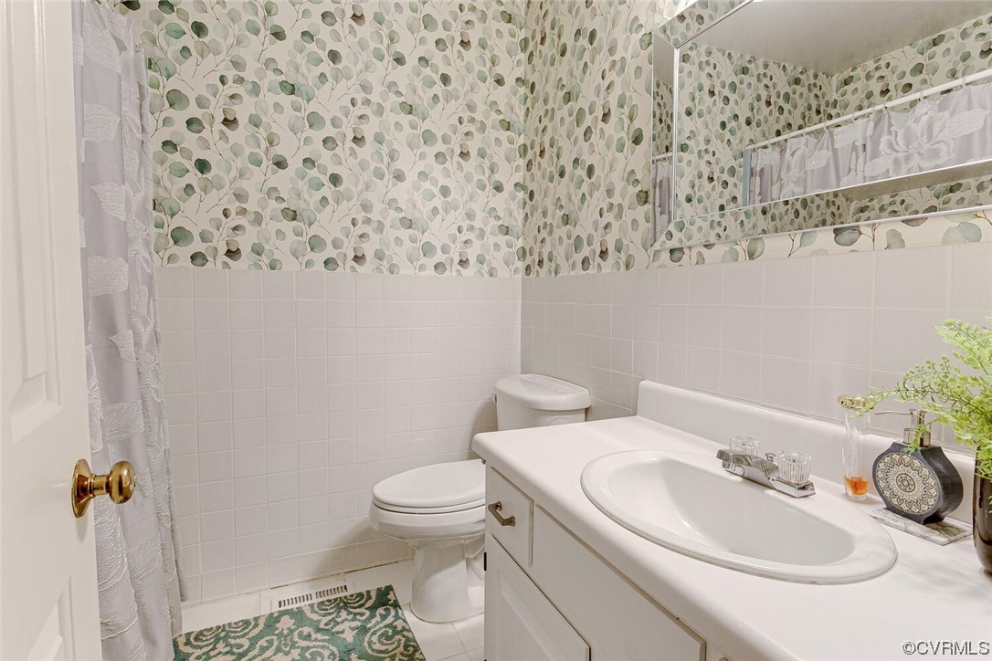 2125 Briarcliff Road Richmond, VA 23225 - Photo 15 of 27 Bathroom featuring oversized vanity, tile walls, tile floors, and mirror