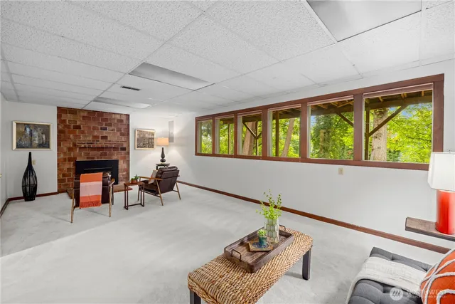 a living room with furniture and a floor to ceiling window