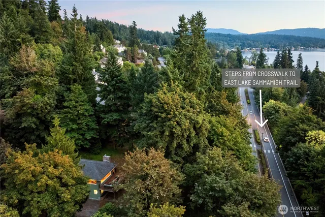 an aerial view of residential house with outdoor space and trees all around
