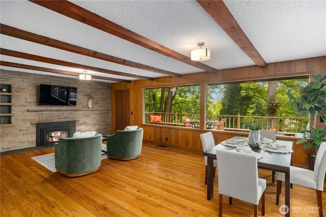 a dining room with furniture and large windows