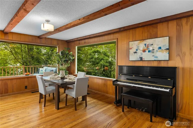 a dining room with furniture and wooden floor