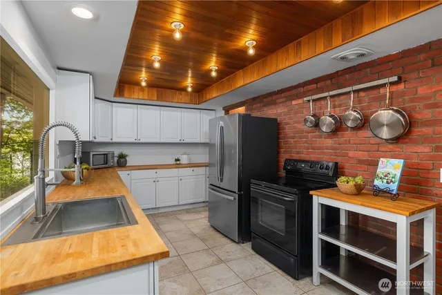 a kitchen with stainless steel appliances granite countertop a sink and stove top oven