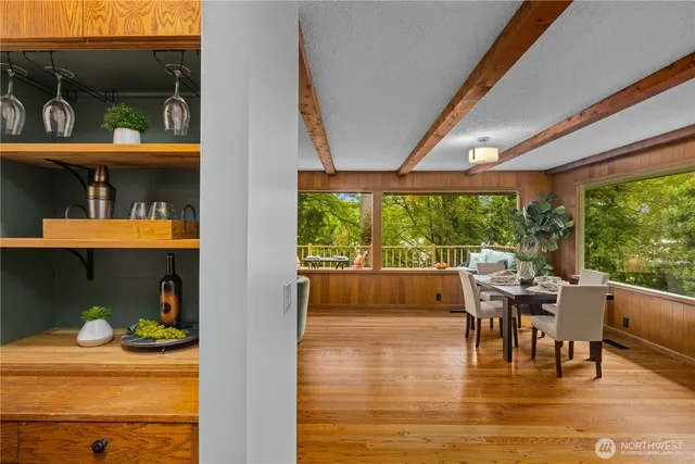 a dining room with furniture and a floor to ceiling window