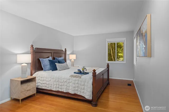 a bedroom with a bed and lamps