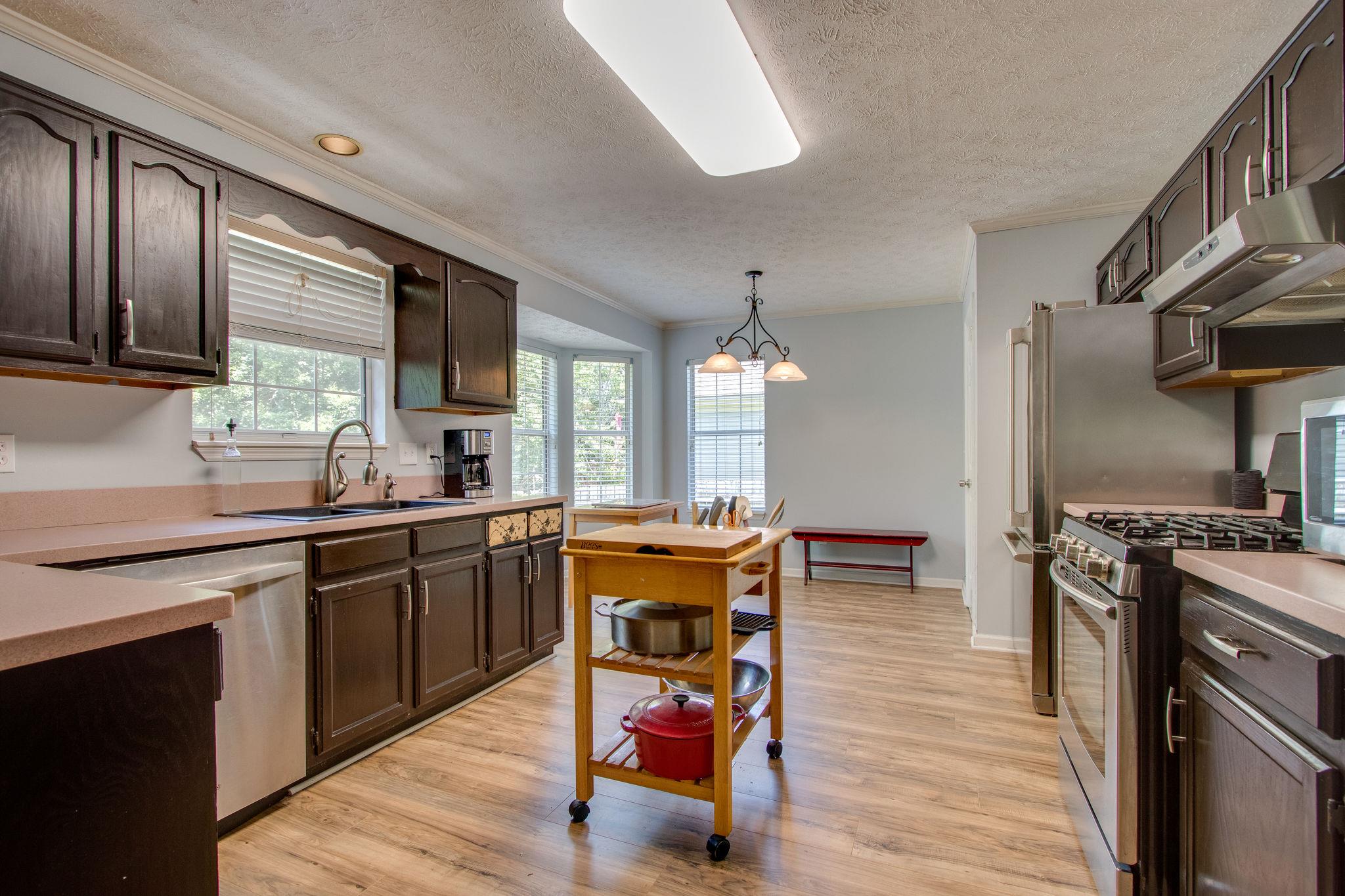 111 Pine Grove Road Mount Juliet, TN 37122 - Photo 5 of 18 Kitchen has a great amount of space and ready for you to update or keep the pink Corian countertops... your choice.