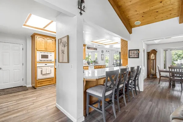 a dining room with furniture and wooden floor