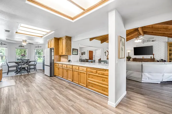 a kitchen with stainless steel appliances kitchen island granite countertop a sink and cabinets