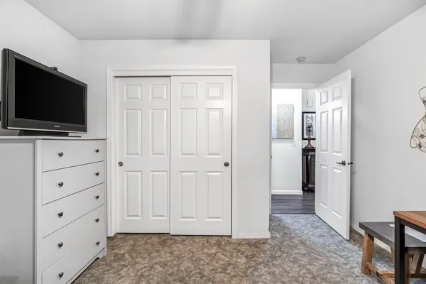 a view of a livingroom with entryway flat screen tv and cabinet