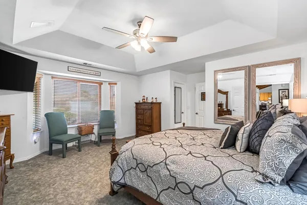 a bedroom with a large bed and flat screen tv