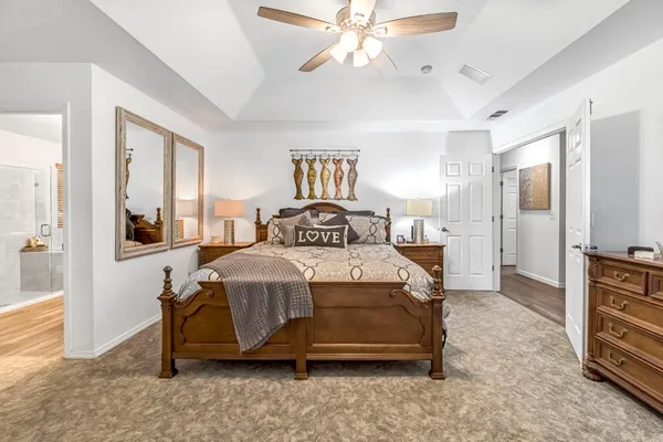 a bedroom with a bed and a chandelier
