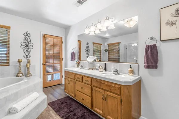 a spacious bathroom with a double vanity sink mirror and double