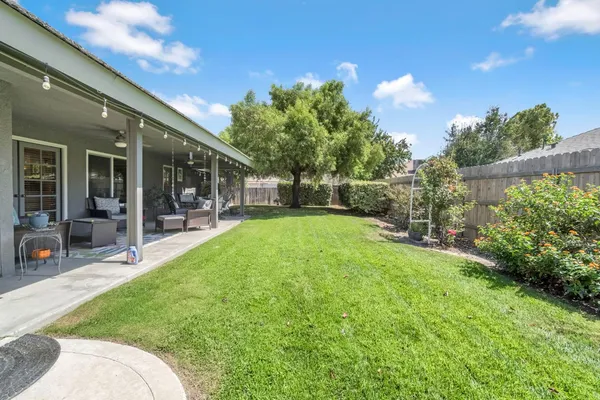 a view of a backyard with sitting area and garden
