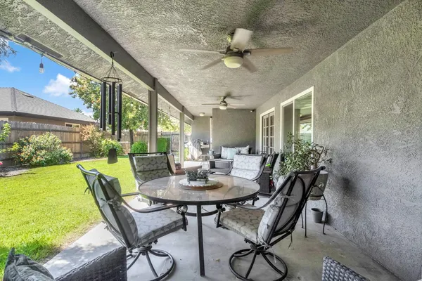 a view of an outdoor dining space with a table and chairs