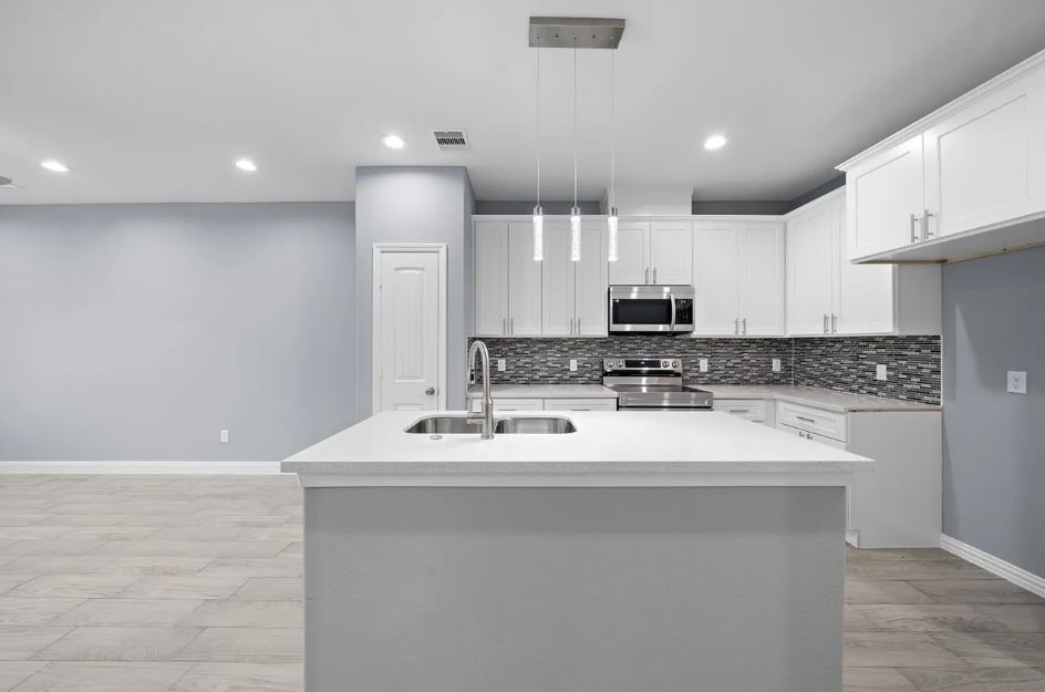5222 Bataan Road Houston, TX 77033 - Photo 8 of 22 Gourmet kitchen featuring stylish cabinetry, sleek countertops, and an open layout ideal for entertaining.