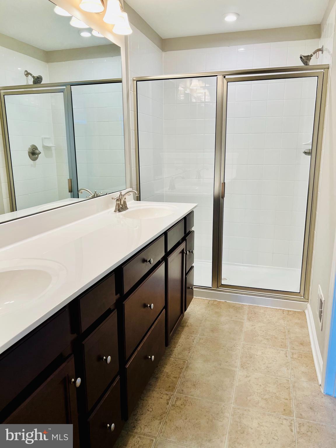 6508 Walcott Lane Frederick, MD 21703 - Photo 13 of 22 a bathroom with a double vanity sink and mirror