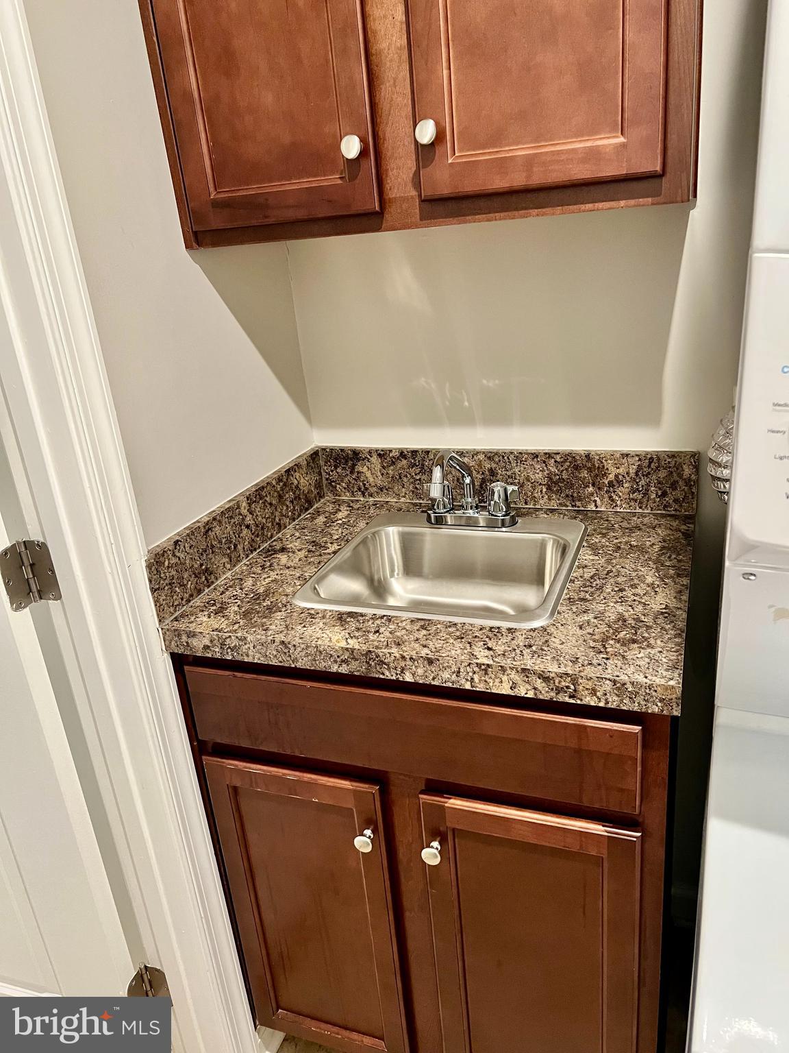 6508 Walcott Lane Frederick, MD 21703 - Photo 20 of 22 a utility room with granite countertop cabinets and utility