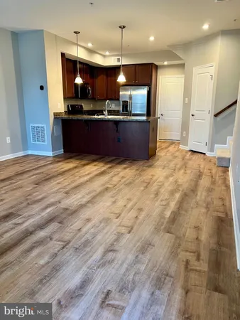 a view of kitchen appliances and wooden floor