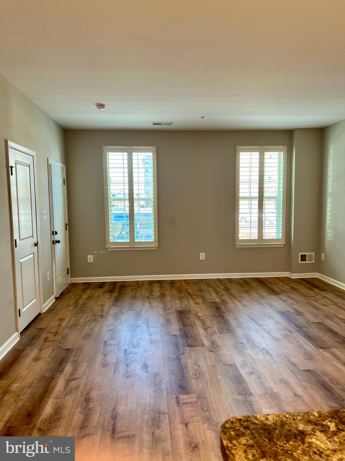 6508 Walcott Lane Frederick, MD 21703 - Photo 4 of 22 an empty room with wooden floor and windows