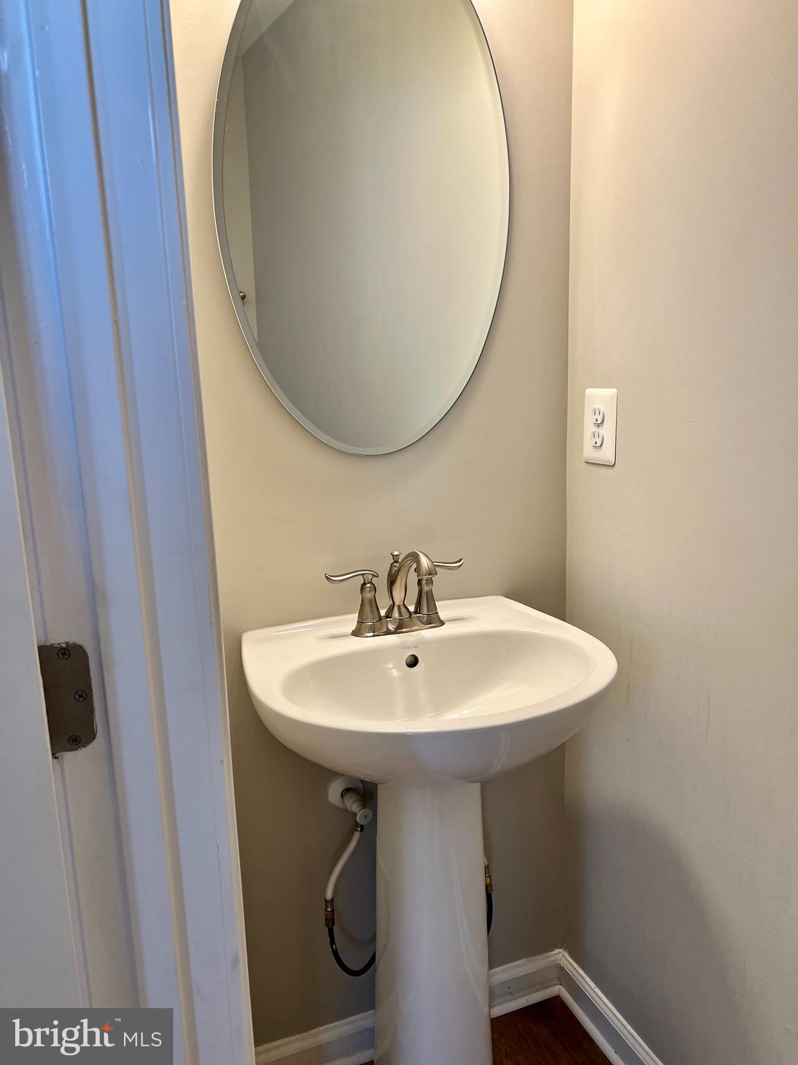 6508 Walcott Lane Frederick, MD 21703 - Photo 7 of 22 a bathroom with a sink a mirror and a toilet
