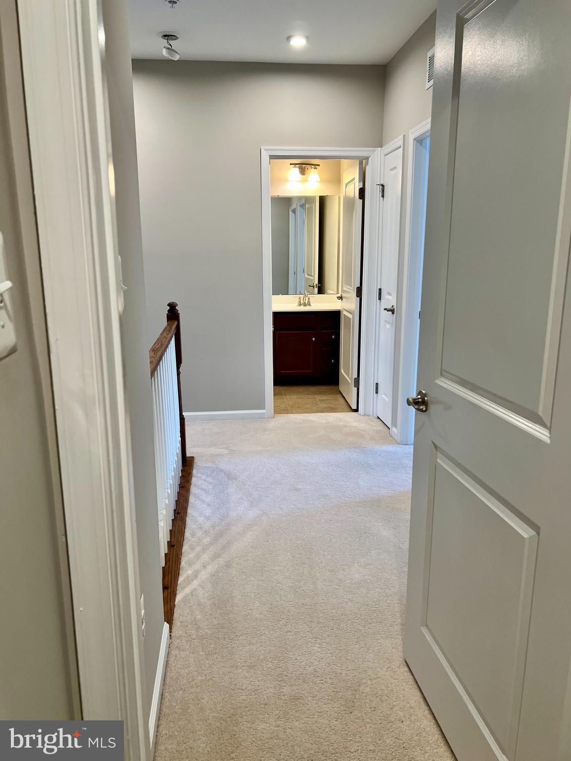 6508 Walcott Lane Frederick, MD 21703 - Photo 9 of 22 a view of a hallway to a room with cabinet and mirror