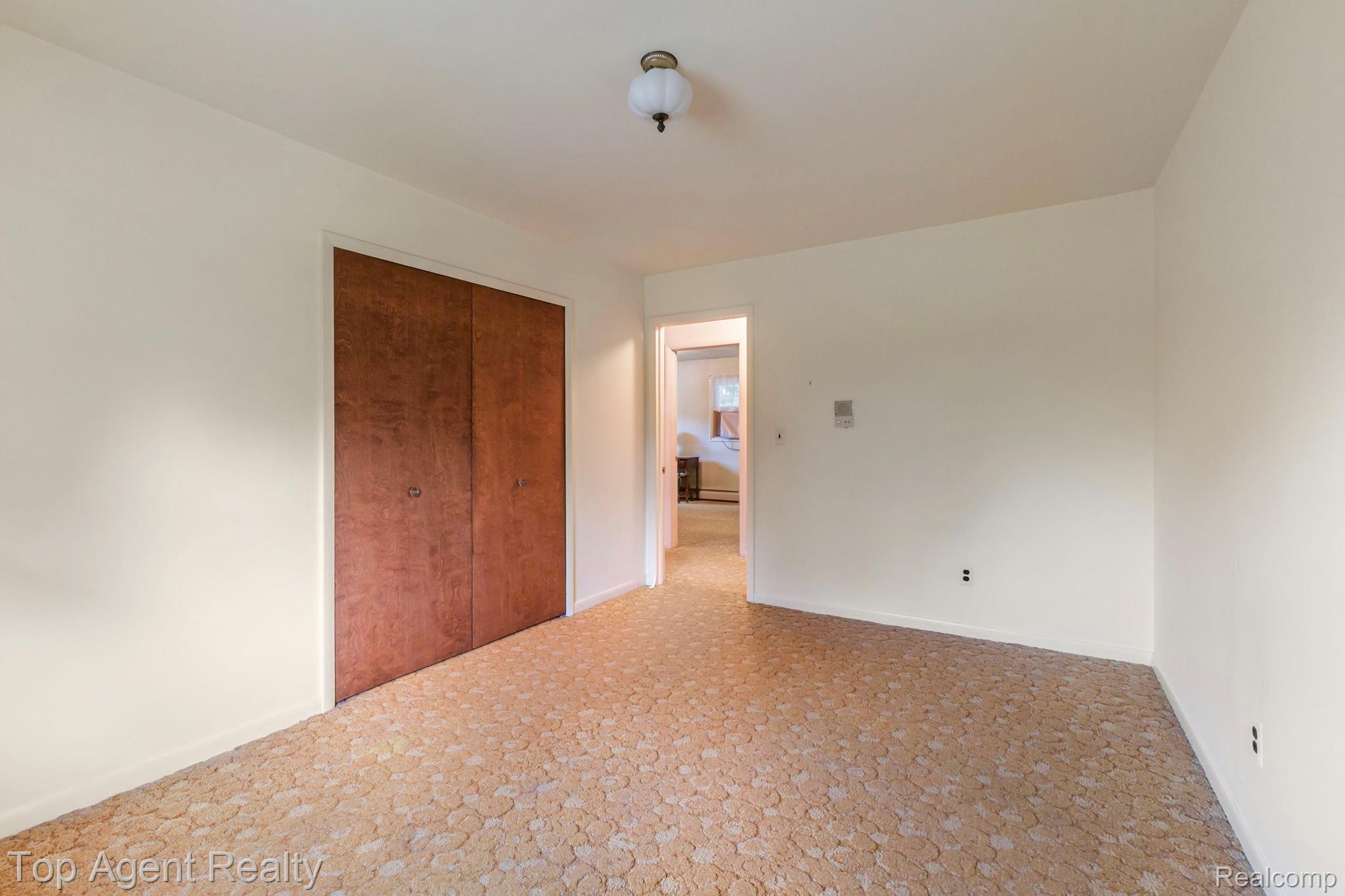 8269 Currie Road Northville, MI 48168 - Photo 31 of 80 Neutral wall tones with wood-finish closet doors