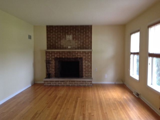 18904 Wolf Road Mokena, IL 60448 - Photo 2 of 10 an empty room with wooden floor a fireplace and windows