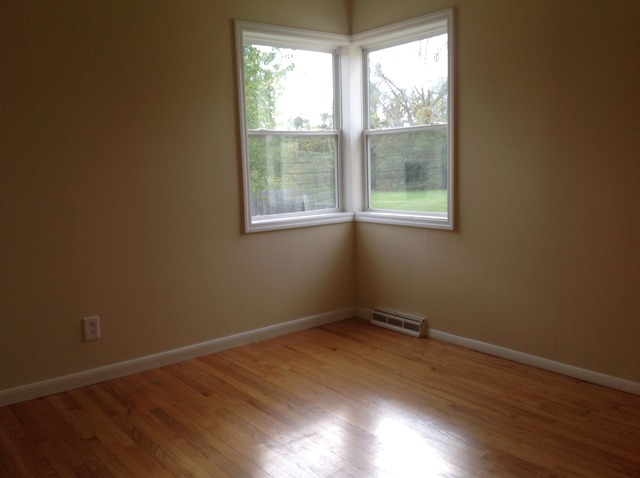 18904 Wolf Road Mokena, IL 60448 - Photo 8 of 10 a view of an empty room with wooden floor and a window