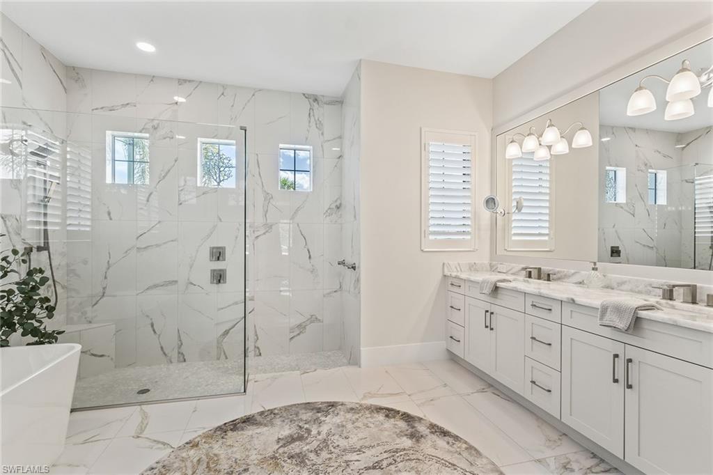 8829 Paradera Court Naples, FL 34112 - Photo 11 of 31 a spacious bathroom with double vanity and a shower