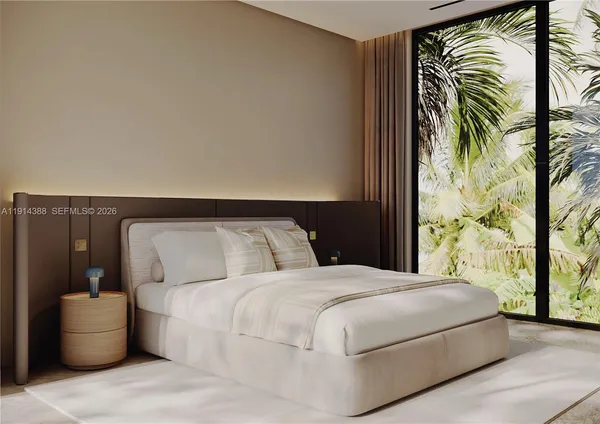 a bedroom with a bed and a painting on the wall