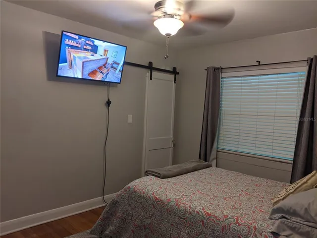 a bedroom with a bed and a painting on the wall