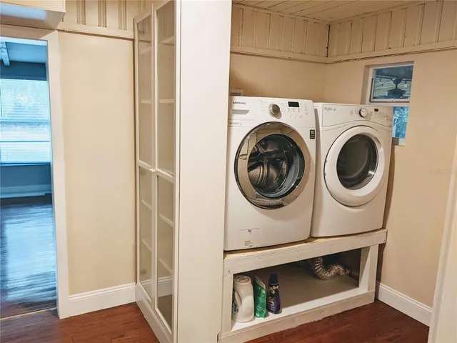 a view of water heater room with wooden floor