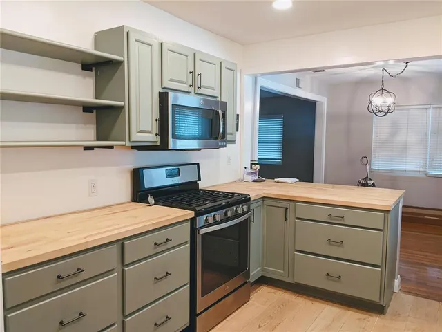 a kitchen with a stove microwave and a sink