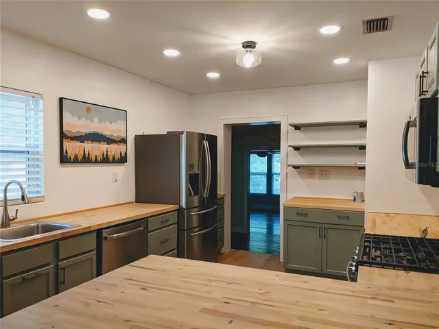 a kitchen with a refrigerator and a sink