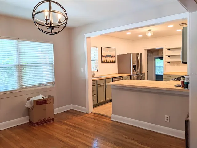 a kitchen with stainless steel appliances granite countertop a stove a sink and a large window