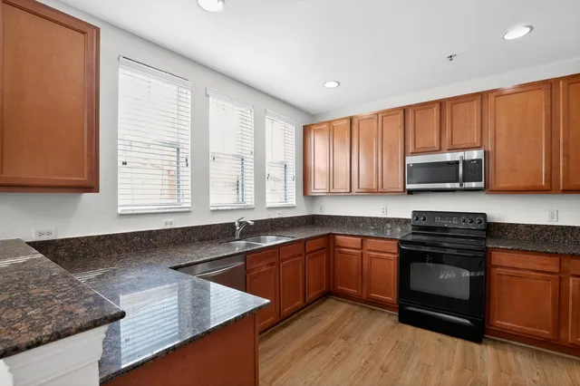 a view of a hallway with wooden floor and entryway
