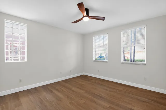 a view of room with hardwood floor and ceiling fan