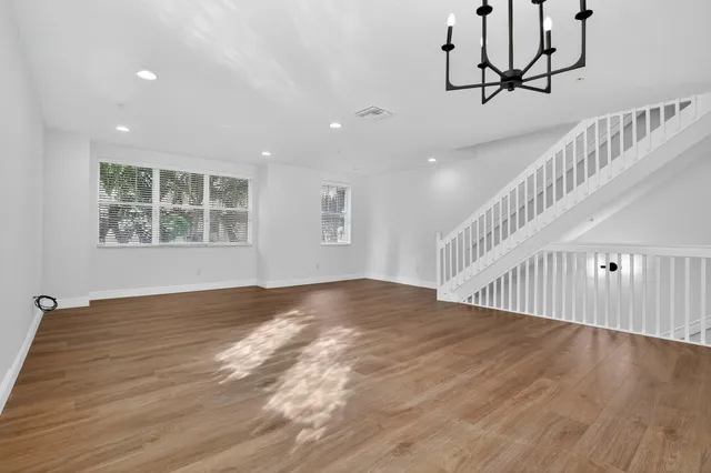 a bathroom with a toilet a sink a mirror a bathtub and vanity