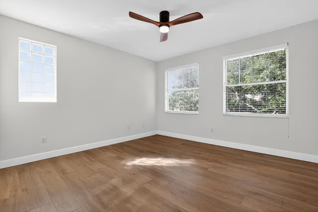 a view of an empty room with wooden floor
