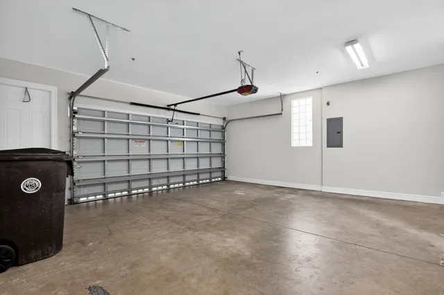 a kitchen with stainless steel appliances granite countertop a refrigerator a sink dishwasher a stove and a oven with wooden floor