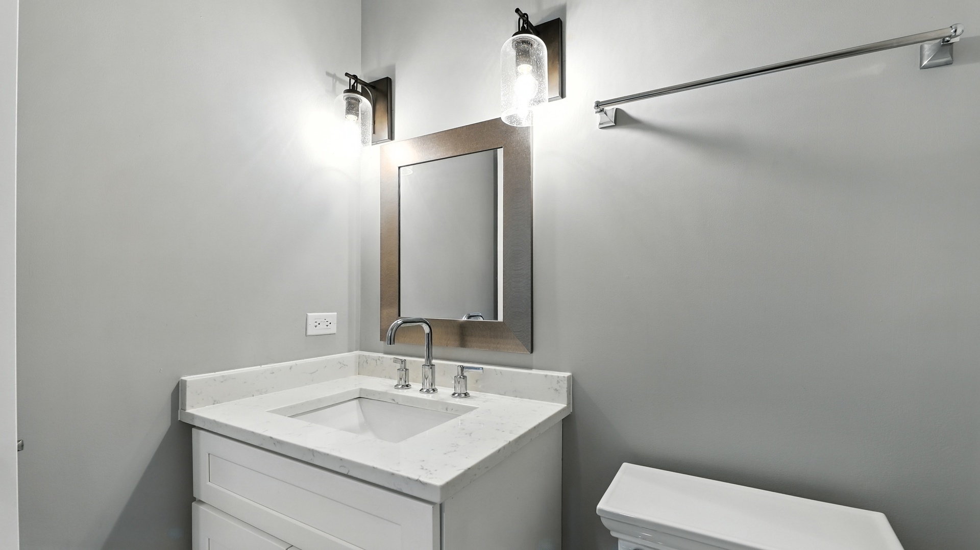 1127 Kenton Road Deerfield, IL 60015 - Photo 26 of 32 a bathroom with a toilet sink and mirror